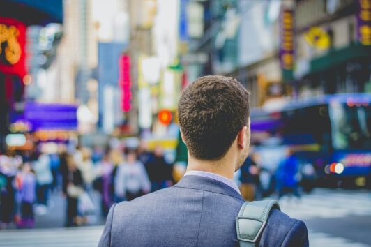 Man in Time's Square walking to his dream job.