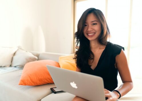 Smiling woman after reviewing the 22 freelancer resources